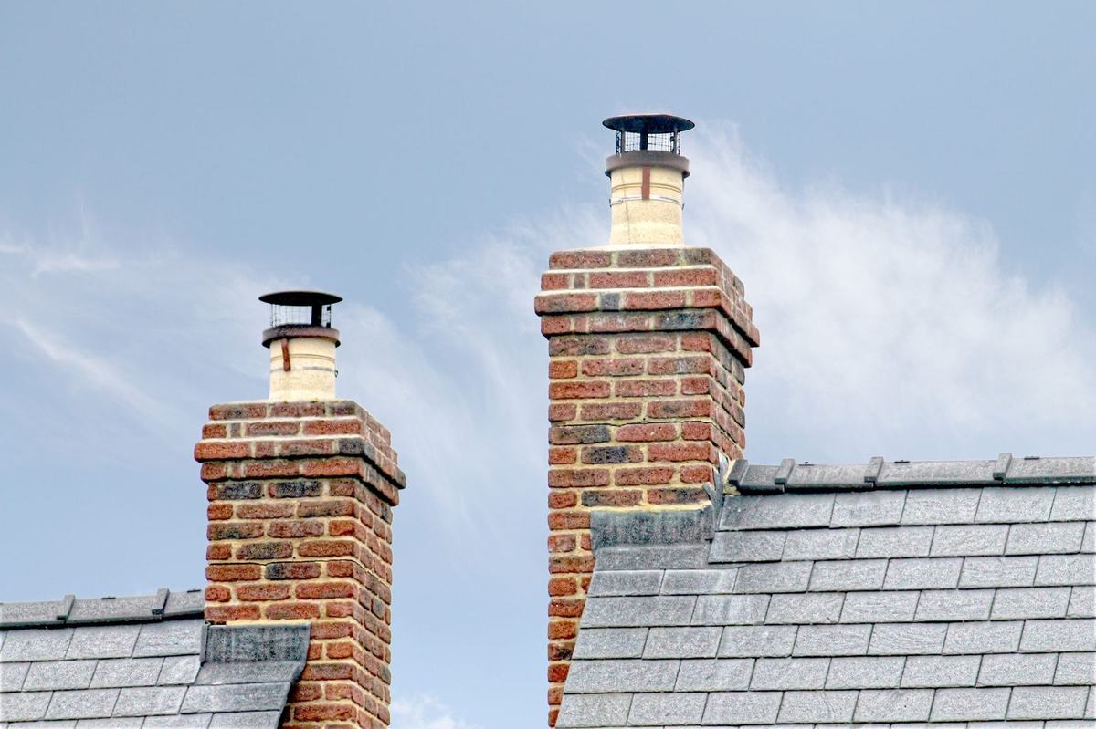 Brick chimneys with cowls on a slate roof